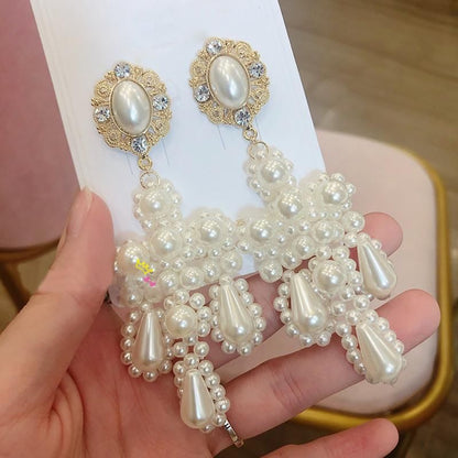 Pearl motif cross earrings